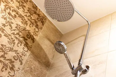 a shower with a shower head in a bathroom at Old Farm House Breg in Žirovnica