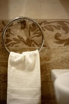 a towel rack with a white towel hanging from it at Old Farm House Breg in Žirovnica