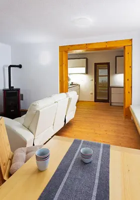 a living room with a couch and a table at Old Farm House Breg in Žirovnica