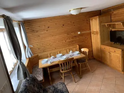 a dining room with a table and chairs in a room at Apartments Nune in Zreče