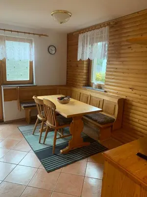 a dining room with a wooden table and chairs at Apartments Nune in Zreče