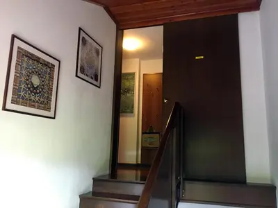 a hallway with a staircase with a door and a mirror at Lookout Resort in the green heart of Slovenia in Rovte