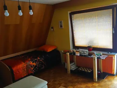 a room with a bed and a large window at Lookout Resort in the green heart of Slovenia in Rovte