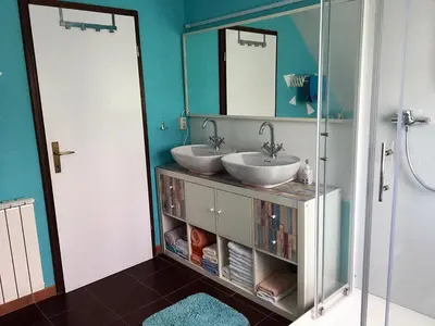 a bathroom with two sinks and a mirror at Lookout Resort in the green heart of Slovenia in Rovte