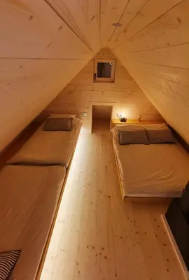 a room with two beds in a tiny house at Chalet Velika Planina with Sauna - I FEEL ALPS in Stahovica
