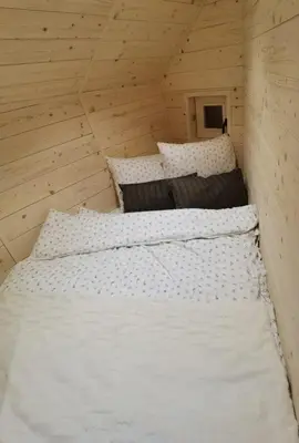 two white beds in a room with wooden walls at Chalet Velika Planina with Sauna - I FEEL ALPS in Stahovica