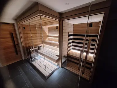 a walk in shower with glass doors in a bathroom at Domačija Metul in Luče
