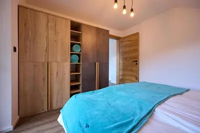 a bedroom with a large bed and wooden cabinets at Domačija Metul in Luče