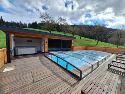 a large deck with a swimming pool on it at Domačija Metul in Luče