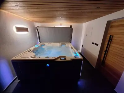 a jacuzzi tub in the middle of a room at Domačija Metul in Luče