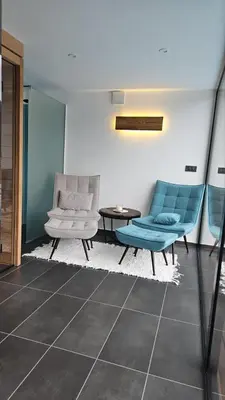 a living room with two blue chairs and a table at Domačija Metul in Luče