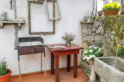 a wooden table with flowers on it next to a sink at Apartma Hiša Pliska in Pliskovica
