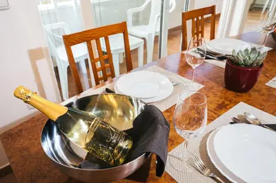 a bottle of champagne in a metal bowl on a table at Aparthotel Rosa 404 in Podčetrtek
