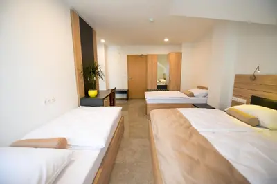 a row of beds in a room at HOTEL BARON in Smlednik