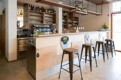a bar with four stools at a counter at HOTEL BARON in Smlednik