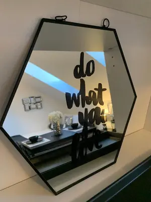 a mirror with a do what you sign on a wall at Apartment Luna in Maribor