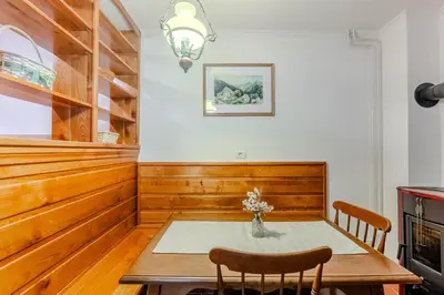 a dining room with a table and chairs at Počitniško stanovanje Pri cerkvi in Trenta
