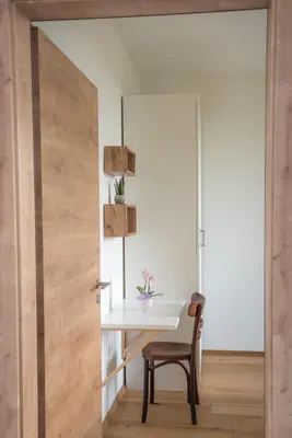 a dining room with a table and a chair at Hiša sonca Toti breg in Svečina
