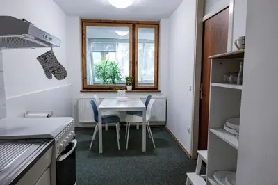 a kitchen with a table and chairs and a window at Dragons Dream Hostel in Ljubljana