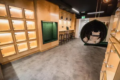 a room with a hanging hammock and a bar at Dragons Dream Hostel in Ljubljana