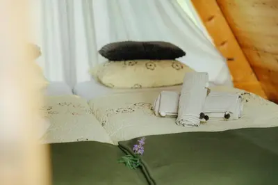 a table with an open book and two pillows at GOZDNE VILE va VRTI in Kostel