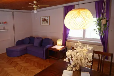 a living room with a blue couch and a table at House Minka in Ptuj