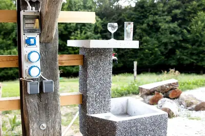 a bird feeder with a wine glass on a tree at Glamping - Hayrack Vesel in Trebnje