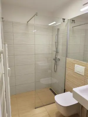 a bathroom with a glass shower with a toilet at Studio Ljubljana in Ljubljana