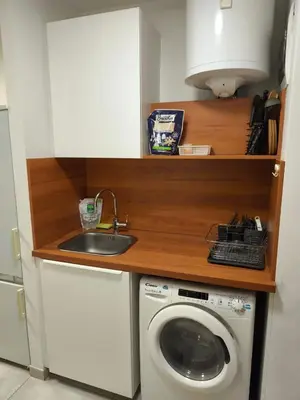 a kitchen with a sink and a washing machine at Studio Ljubljana in Ljubljana