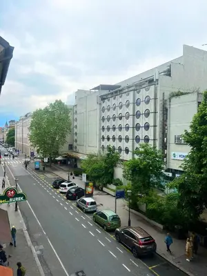 a building with cars parked on the side of a street at Studio Ljubljana in Ljubljana