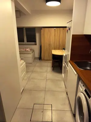 a kitchen with a sink and a table in a room at Studio Ljubljana in Ljubljana