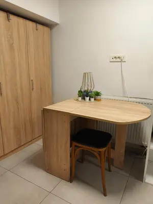 a wooden table with a chair and a lamp on it at Studio Ljubljana in Ljubljana