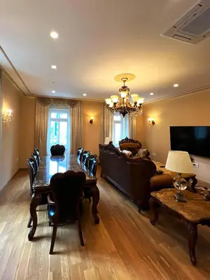 a living room with a table and a chandelier at Apartment Ljubljana in Ljubljana
