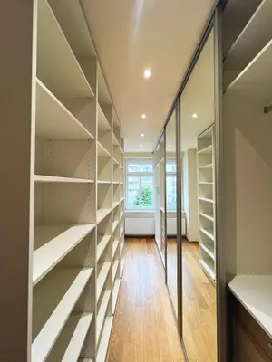 a walk in closet with glass shelves at Apartment Ljubljana in Ljubljana