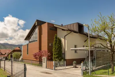 a house with a fence in front of it at Apartment Franko in Radovljica