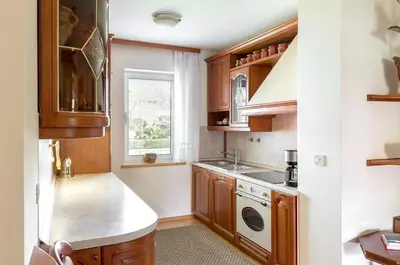 a kitchen with wooden cabinets and a sink at Apartment Franko in Radovljica