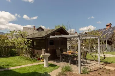 a backyard with a table and a pergola at Apartment Franko in Radovljica