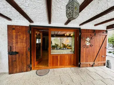 a wooden entry door to a house with a window at Red Beech Cabin - An Alpine Cabin near Lake Bohinj in Bohinj