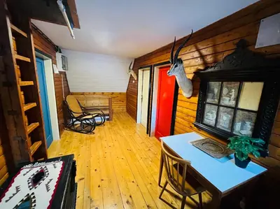 a room with a table and chairs in a house at Red Beech Cabin - An Alpine Cabin near Lake Bohinj in Bohinj