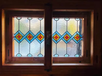 a door with a glass window in a room at Red Beech Cabin - An Alpine Cabin near Lake Bohinj in Bohinj