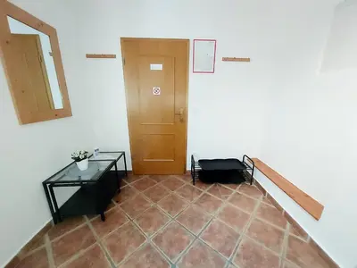a hallway with a door and a tiled floor at Villa Nebina in Rateče