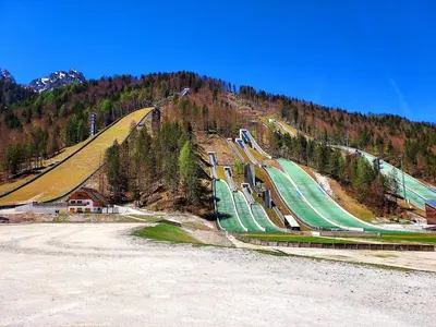 a train on a hill with a mountain at Villa Nebina in Rateče
