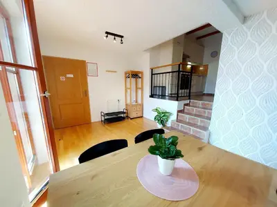 a dining room table with a potted plant on it at Villa Nebina in Rateče