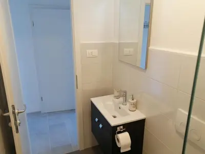 a bathroom with a sink and a mirror at Apartments Rosemary Ljubljana & Free Parking in Ljubljana