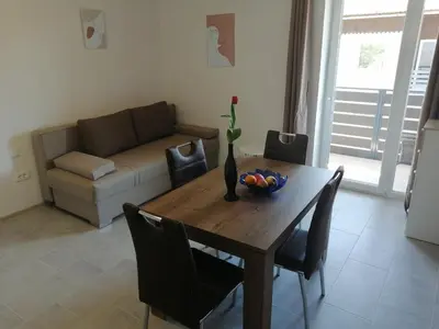 a living room with a wooden table and a couch at Apartments Rosemary Ljubljana & Free Parking in Ljubljana