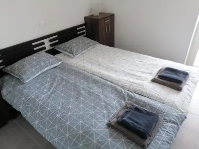 a bedroom with two beds with blue towels on them at Apartments Rosemary Ljubljana & Free Parking in Ljubljana