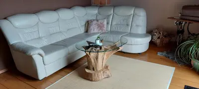 a living room with a white couch and a table at Vineyard cottage Stopar in Straža