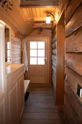a hallway of a tiny house with a door at Wood house Irena-Počitniška hiša in Bohinj