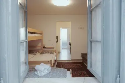 a bedroom with two bunk beds and a hallway at Apartments Pr' Štormanu in Kanal