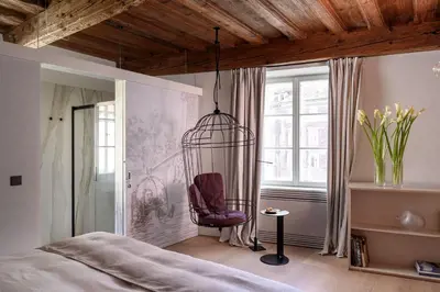 a bedroom with a chair in a cage at Zlata Ladjica Boutique Hotel in Ljubljana